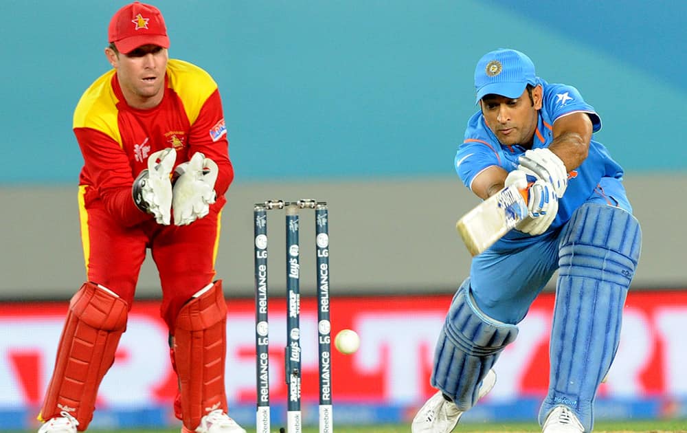 MS Dhoni plays a shot as Zimbabwe's Brendan Taylor watches during their Cricket World Cup Pool B match in Auckland, New Zealand.