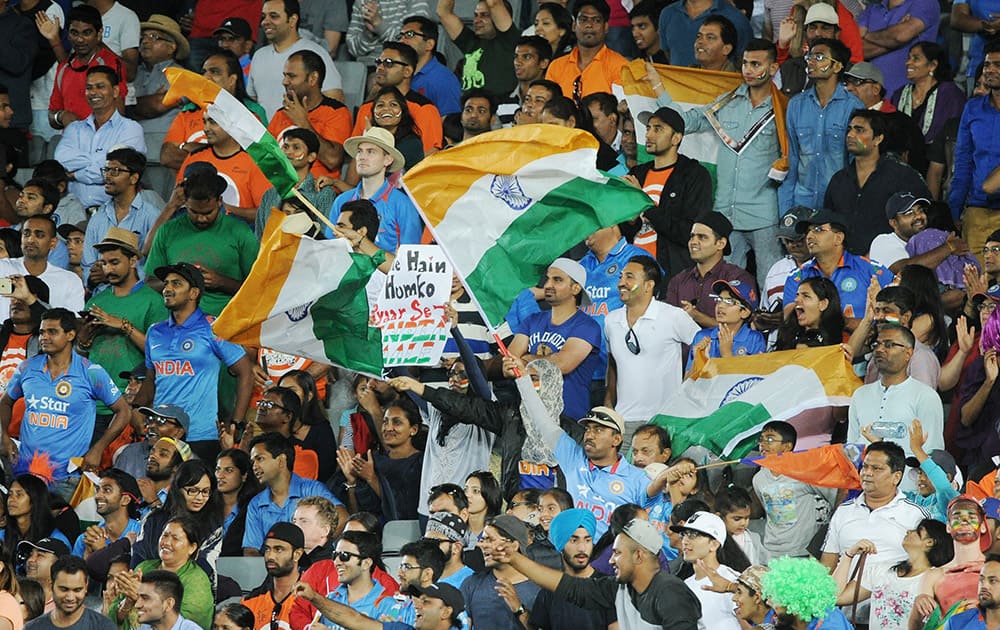 Supporters wave flags as they cheer their team on during their Cricket World Cup Pool B match against Zimbabwe in Auckland, New Zealand.