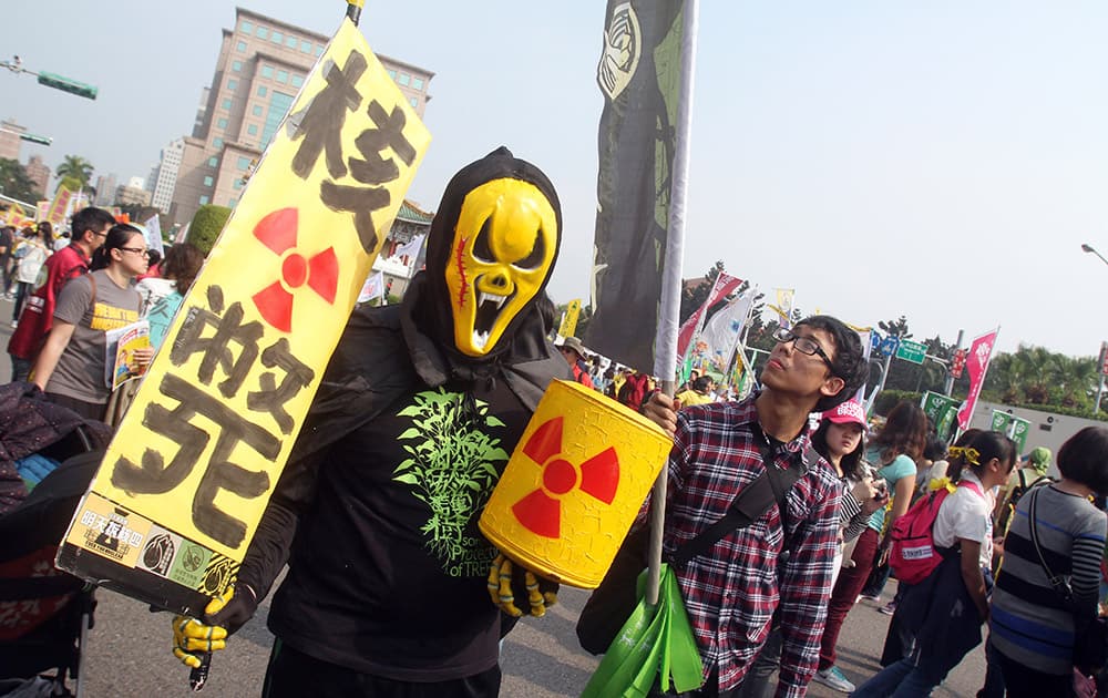 A protester holds a slogan reading 'Nuke Death' during an anti-nuclear demonstration in Taipei, Taiwan.