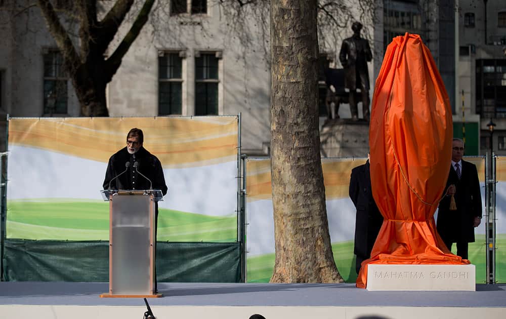 Amitabh Bachchan makes a speech next to a new statue of Mahatma Gandhi by British sculptor Philip Jackson before it was unveiled in Parliament Square, London.