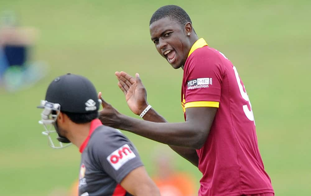 West Indies bowler Jason Holder, right, appeals successfully for the dismissal of United Arab Emirates batsman Amjad Ali during their Cricket World Cup Pool B match in Napier, New Zealand.