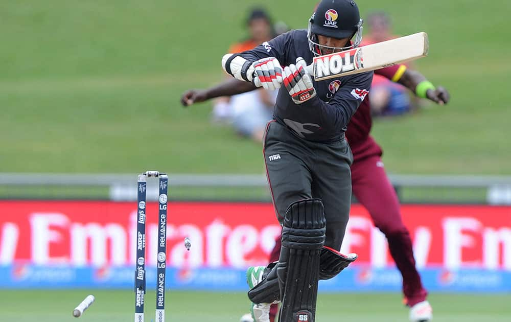 United Arab Emirates Khurram Khan is bowled by West Indies Jerome Taylor for five runs during their Cricket World Cup Pool B match in Napier, New Zealand.