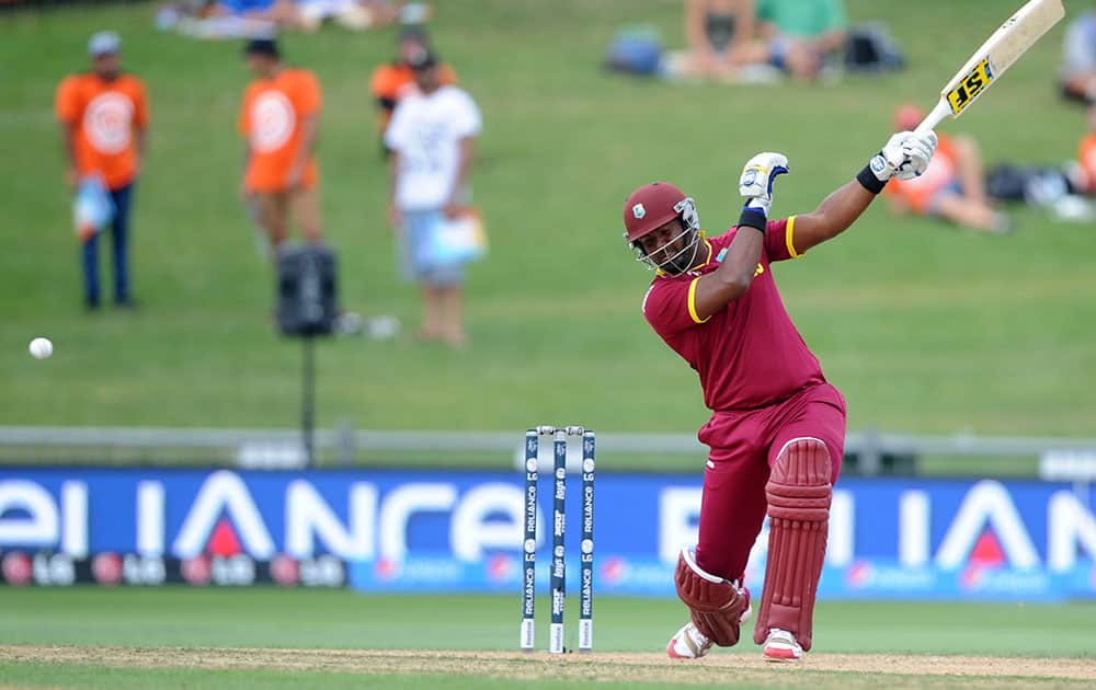 West Indies batsman Dwayne Smith swings at the ball while batting against the United Arab Emirates during their Cricket World Cup Pool B match in Napier, New Zealand.