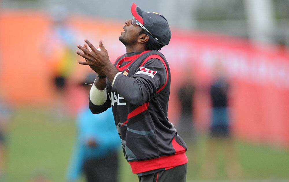 United Arab Emirates Krishna Karate takes a catch to dismiss West Indies batsman Johnson Charles during their Cricket World Cup Pool B match in Napier, New Zealand.