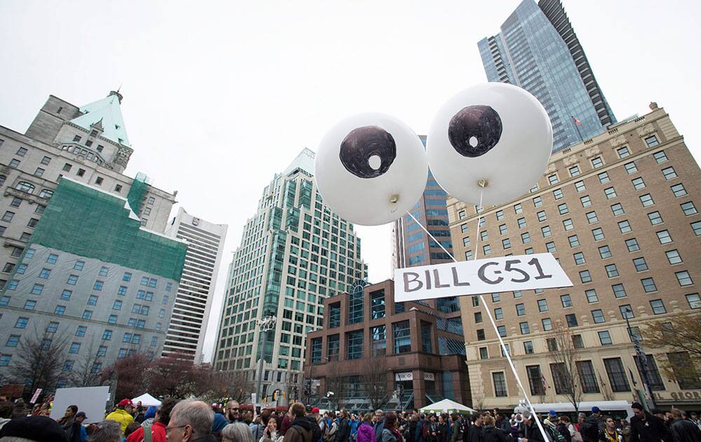 A demonstrator flies a giant pair of eyes over a protest on a national day of action against Bill C-51, the government's proposed anti-terrorism legislation, outside the Vancouver Art Gallery in downtown Vancouver, British Columbia.
