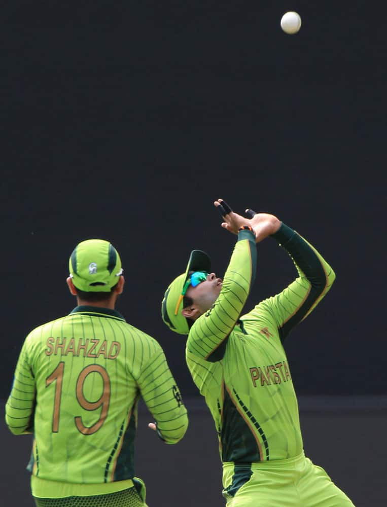 Pakistan’s Umar Akmal, right, prepares to take a catch to dismiss Ireland’s Ed Joyce during their Cricket World Cup Pool B match in Adelaide, Australia.