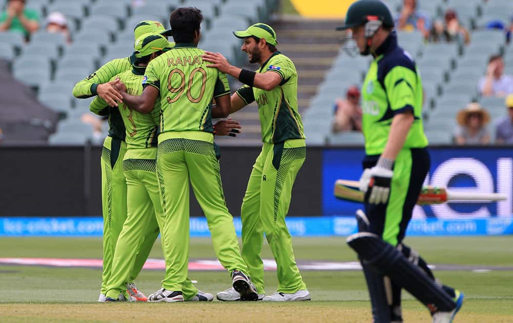 Ireland's Niall O'Brien walks back after his dismissal as Pakistan players celebrate during their Cricket World Cup Pool B match in Adelaide, Australia.