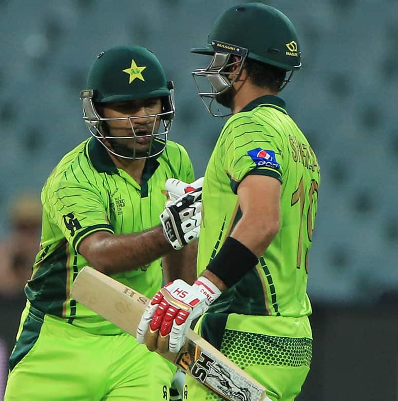 Pakistan’s Sarfraz Ahmed, left congratulates teammate Ahmed Shahzad, for his fifty runs during their Cricket World Cup Pool B match against Ireland in Adelaide, Australia.