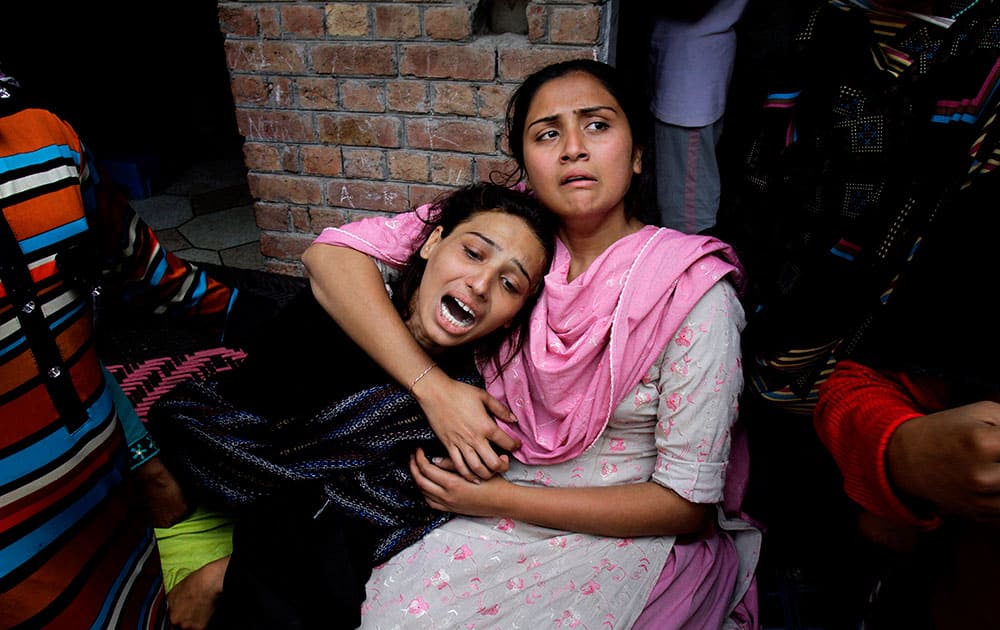 Pakistani Christian girls mourn over a family member who was killed from a suicide bombing attack near two churches in Lahore, Pakistan.