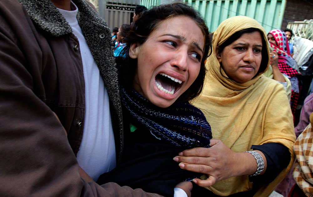 A Pakistani Christian woman mourns over a family member who was killed from a suicide bombing attack near two churches in Lahore, Pakistan.