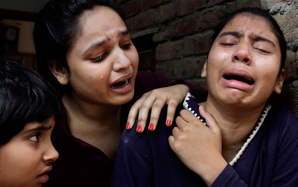 Pakistani Christian girls mourn over a family member who was killed from a suicide bombing attack near two churches in Lahore, Pakistan.