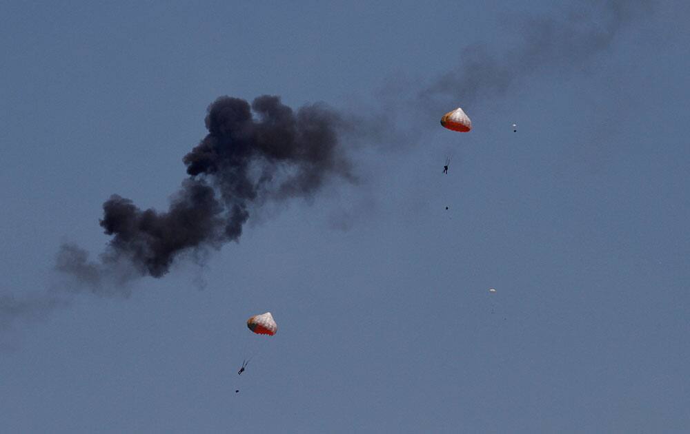 Pilots from Indonesia’s Jupiter aerobatics team are ejected after a mid-air collision during a practice session at the Langkawi International Maritime and Aerospace (LIMA) exhibition in Langkawi, Malaysia.