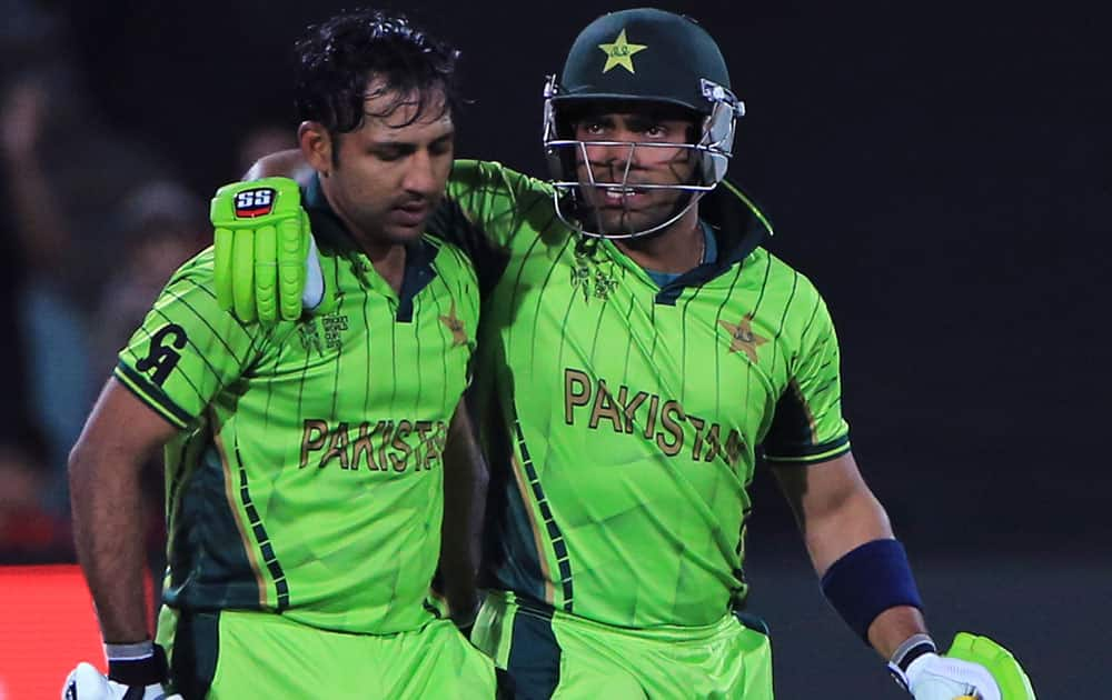 Pakistan’s Umar Akmal, right, congratulates Sarfraz Ahmed, who scored his hundred runs during their Cricket World Cup Pool B match against Ireland in Adelaide, Australia.