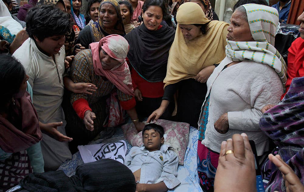 A Pakistani Christian family mourn over the lifeless body of a boy who was killed from a suicide bombing attack near two churches in Lahore, Pakistan.