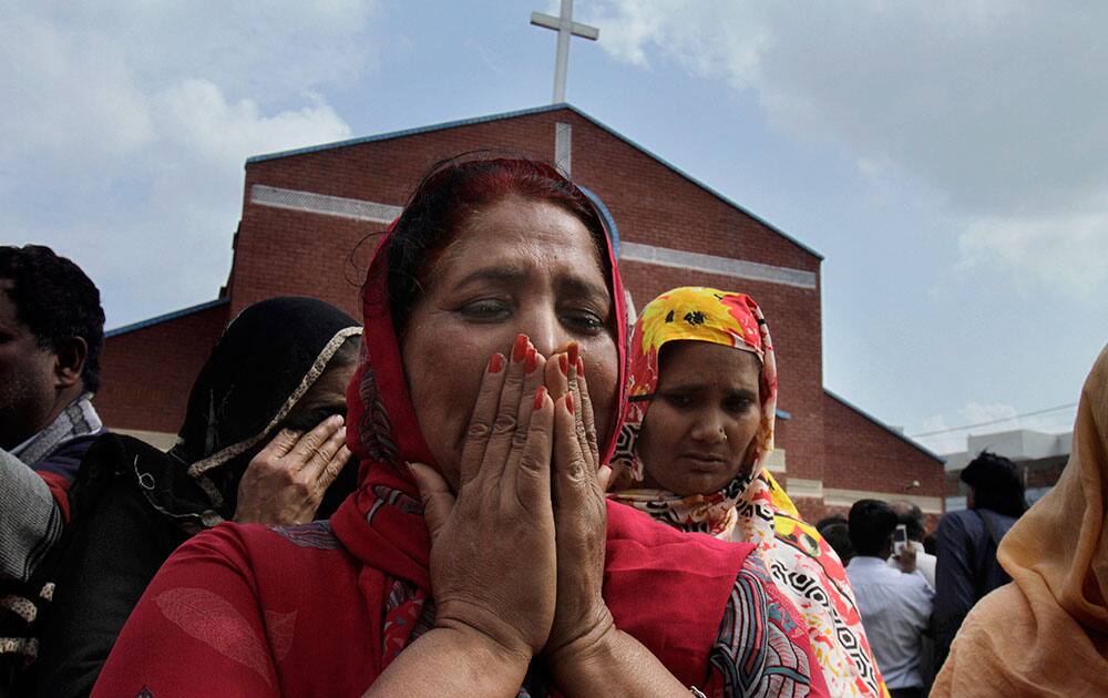 Pakistani Christian women mourn as they gather at a church damaged from a suicide bombing attack in Lahore, Pakistan.