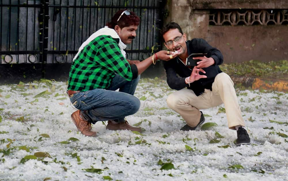 People click selfies after a spell of heavy hailstorm in Nagpur.