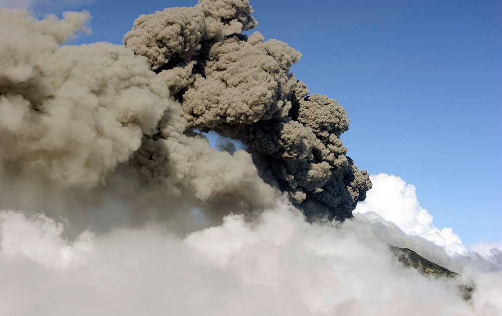 a column of ash and smoke erupts from the Turrialba volcano in Turrialba, Costa Rica. 