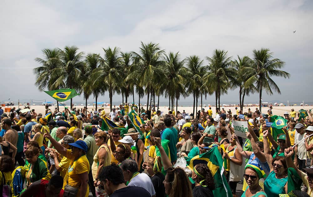 People march to protest the government of Brazil's President Dilma Rousseff along Copacabana beach in Rio de Janeiro, Brazil.