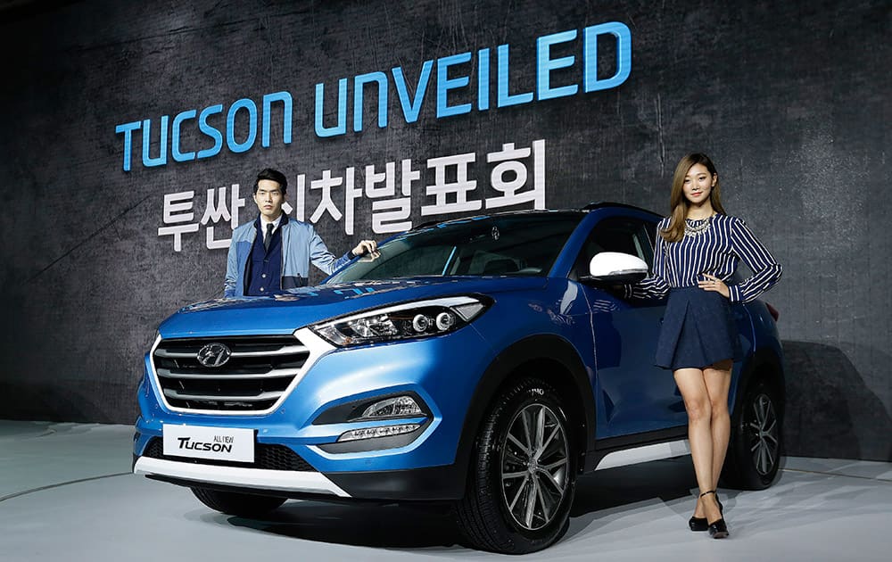 South Korean models pose with Hyundai Motors' all-new Tucson SUV during a press unveiling in Seoul, South Korea. The vehicle, equipped with a U2 1.7 diesel engine or R2.0 diesel engine, are priced from 23.4 million won (US$20,763) to 29.2 million won (US$25,909) .