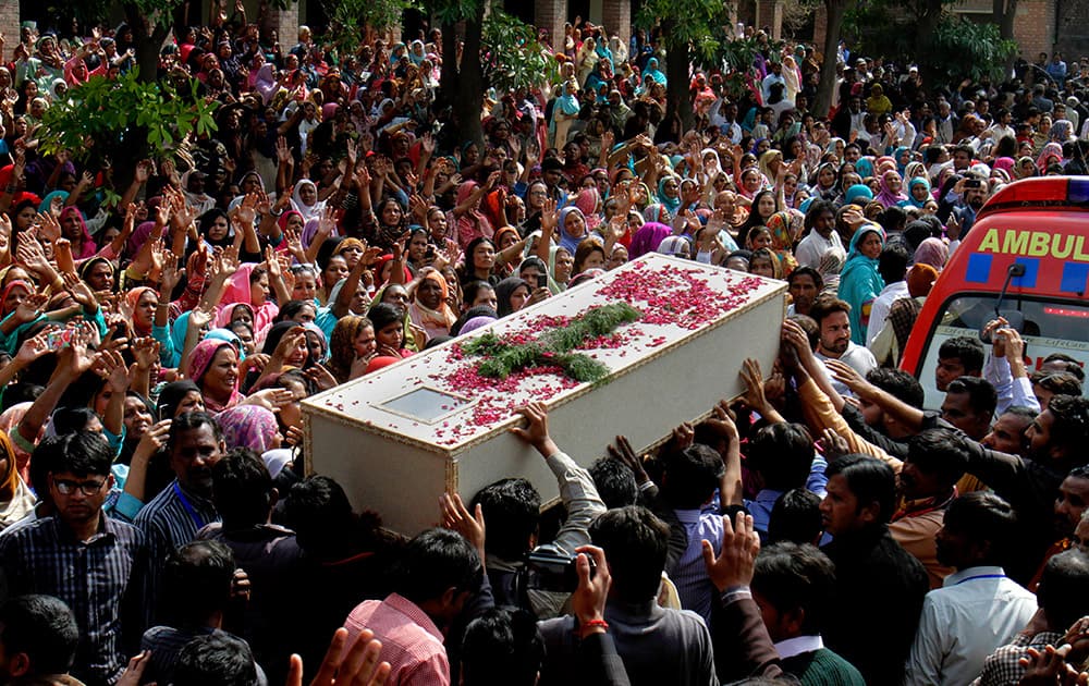 Pakistani Christians carry a casket of a victim of Sunday's pair of suicide attacks on two churches during a mass funeral service in Lahore.