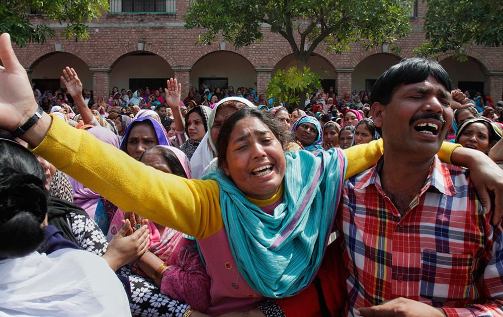 Pakistani Christians mourn during the mass funeral service of the victims of Sunday's pair of suicide attacks on two churches in Lahore, Pakistan.