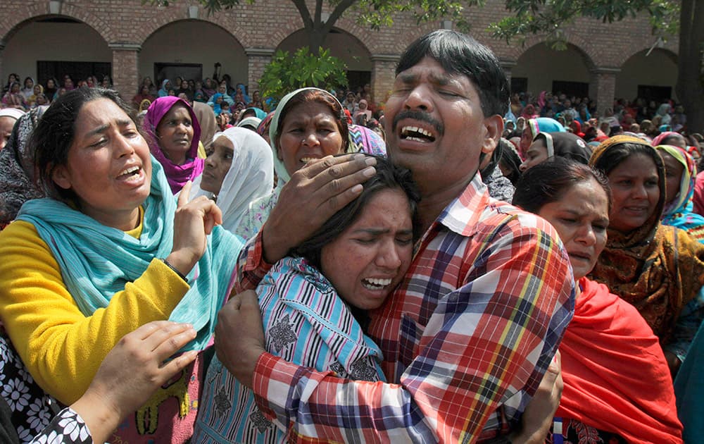 Pakistani Christians mourn during the mass funeral service of victims of Sunday's pair of suicide attacks on two churches in Lahore, Pakistan.