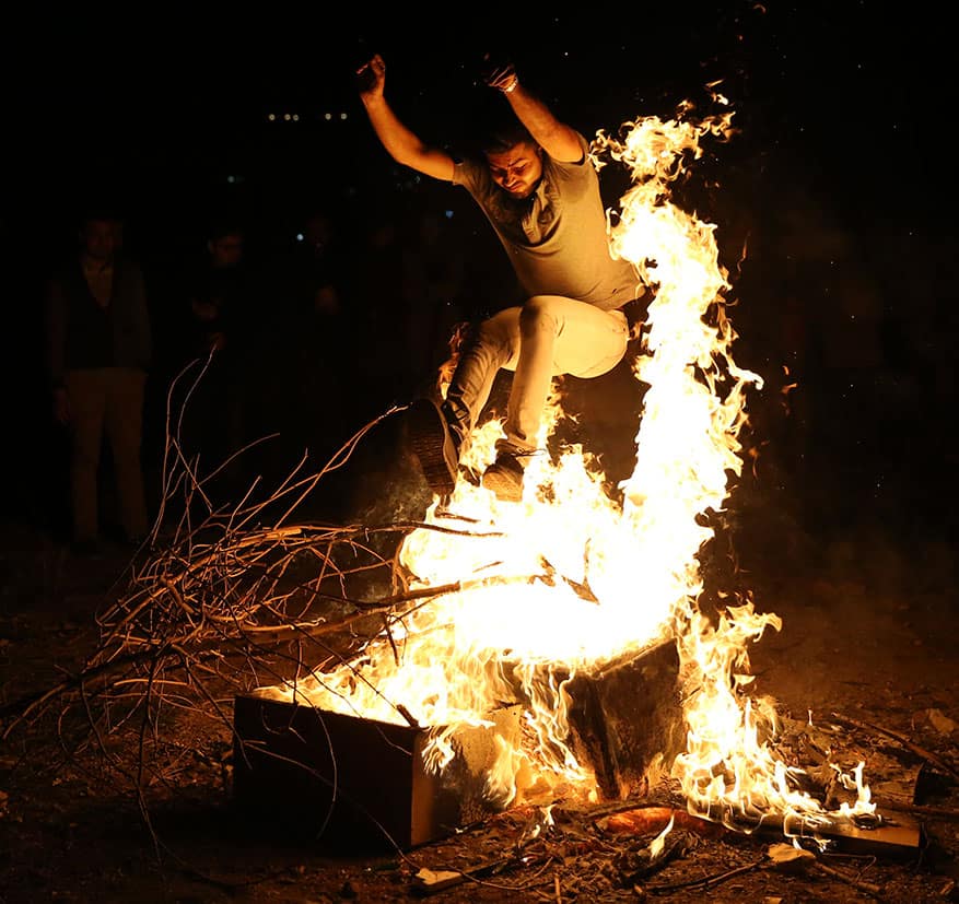 An Iranian man jumps over a bonfire during Chaharshanbe Souri, or Wednesday Feast, an ancient Festival of Fire, on the eve of the last Wednesday of the solar Persian year, in Tehran, Iran.