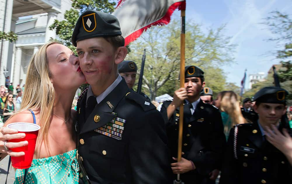 A cadet at the Benedictine Military School gets kissed while marching in the 191st St. Patrick's Day parade, in Savannah, Ga. 