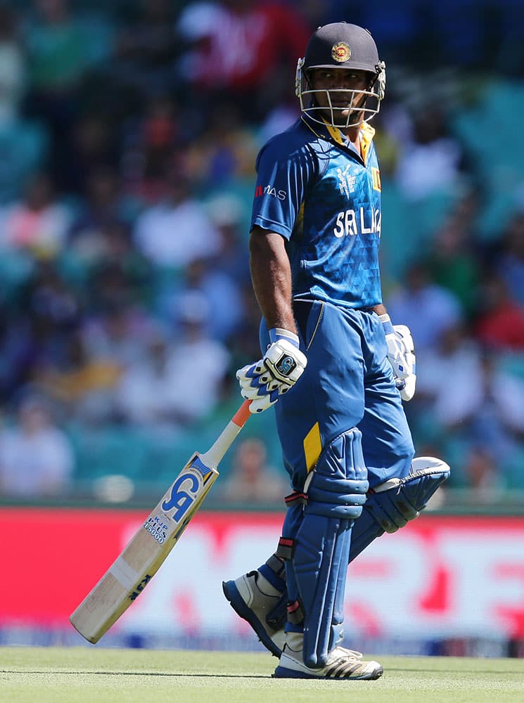 Sri Lanka's Kusal Perera walks from the field after he was dismissed for three runs during their Cricket World Cup quarterfinal match against South Africa in Sydney, Australia.