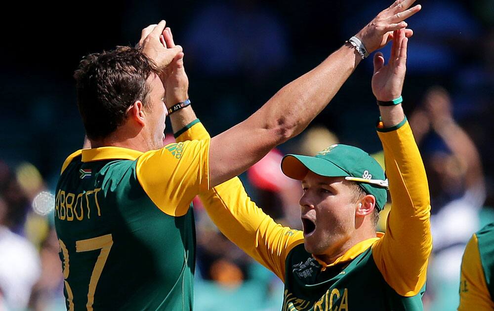 South Africa's Kyle Abbott, left, celebrates with teammate David Miller the dismissal of Sri Lanka's Kusal Perera during their Cricket World Cup quarterfinal match in Sydney, Australia.