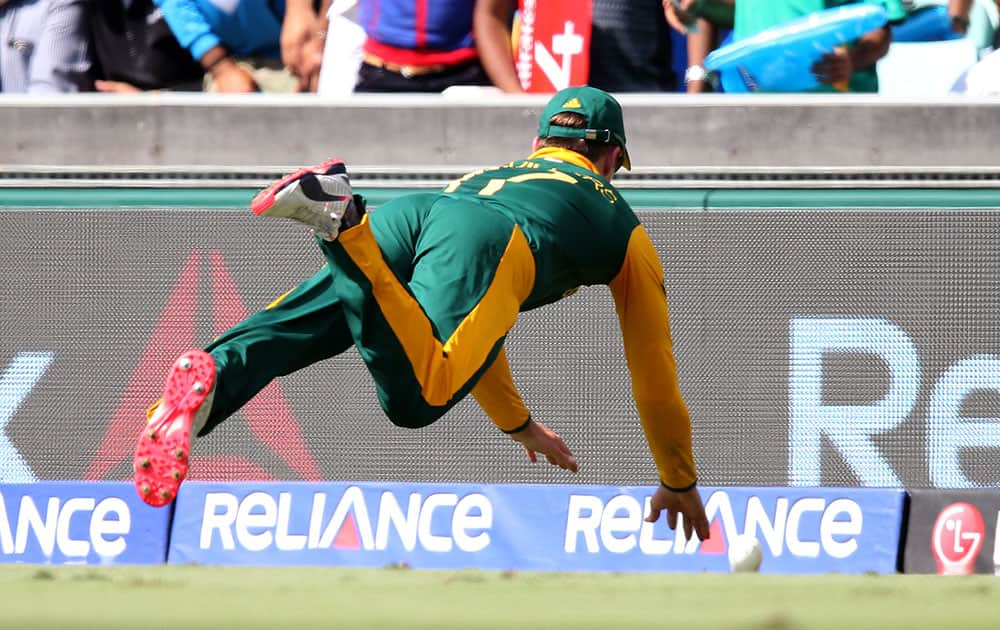 South Africa's AB de Villiers is airborne as he attempts to field the ball during their Cricket World Cup quarterfinal match against Sri Lanka in Sydney, Australia.