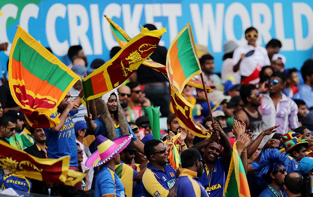 Sri Lankan fans cheer their team on during their Cricket World Cup quarterfinal match against South Africa in Sydney, Australia.