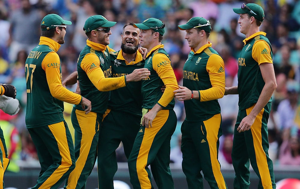 South Africa's Imran Tahir is congratulated by teammates after taking the wicket of Sri Lanka's Thisara Perera during their Cricket World Cup quarterfinal match in Sydney, Australia.