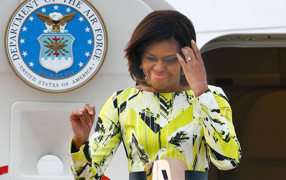 United States first lady Michelle Obama walks down the ramp upon her arrival at Haneda International Airport in Tokyo.