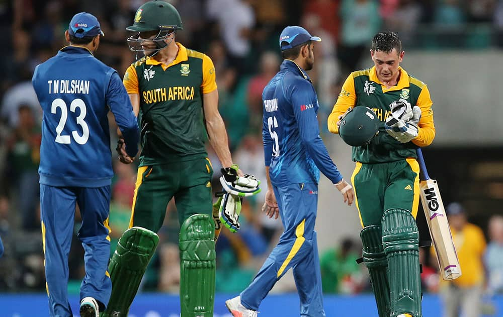 South Africa's Francois Du Plessis is congratulated by Sri Lanka's Tillakaratne Dilshan, left, as teammate Quinton De Kock, right, is congratulated by Sri Lanka's Lahiru Thirimanne following their nine wicket win in their Cricket World Cup quarterfinal match in Sydney, Australia.