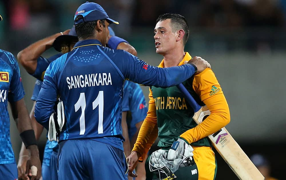 Sri Lanka's Kumar Sangakkara talks with South African batsman Quinton De Kock after South Africa's nine wicket win in their Cricket World Cup quarterfinal match in Sydney, Australia.