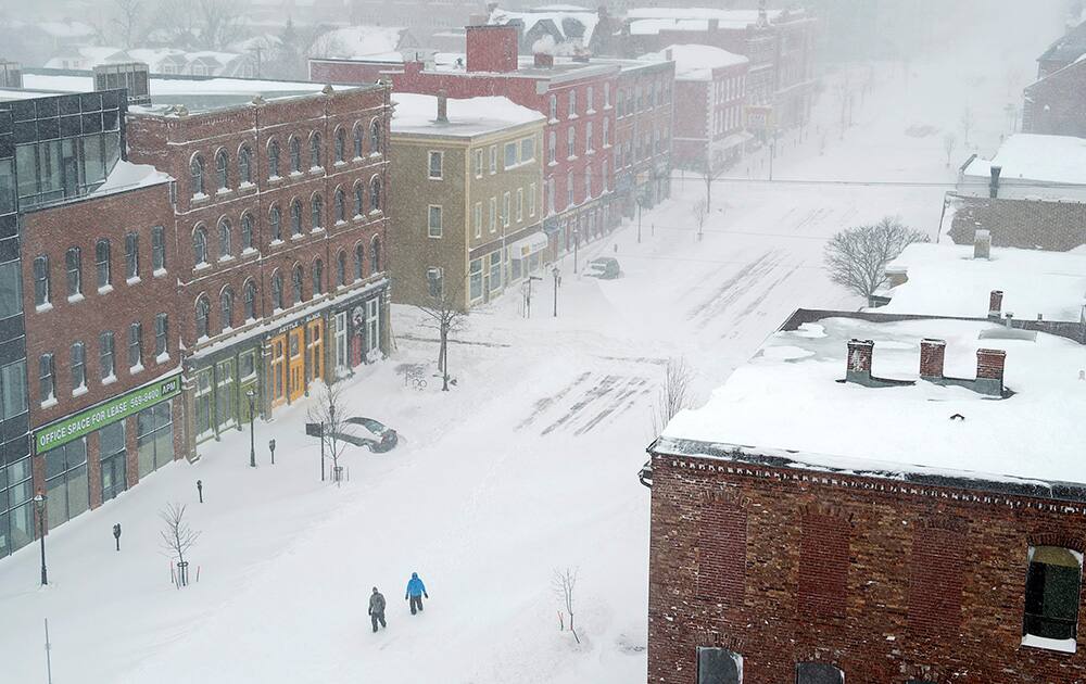 Pedestrians brave the elements as they walk in downtown Charlottetown, Prince Edward Island.