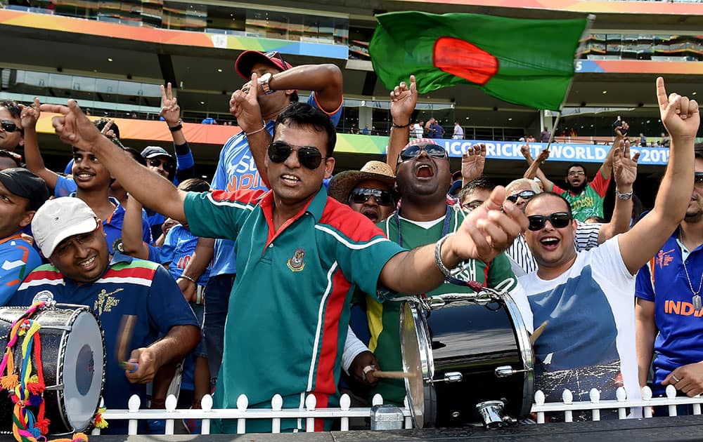 Bangladesh fans wave flags and cheer during their team's Cricket World Cup quarterfinal match against India in Melbourne, Australia.