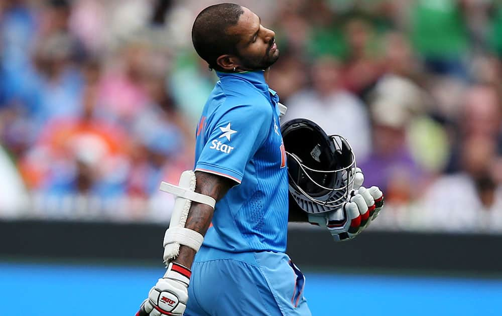 India's Shikhar Dhawan walks from the field after he was out stumped during their Cricket World Cup quarterfinal match against Bangladesh in Melbourne, Australia.