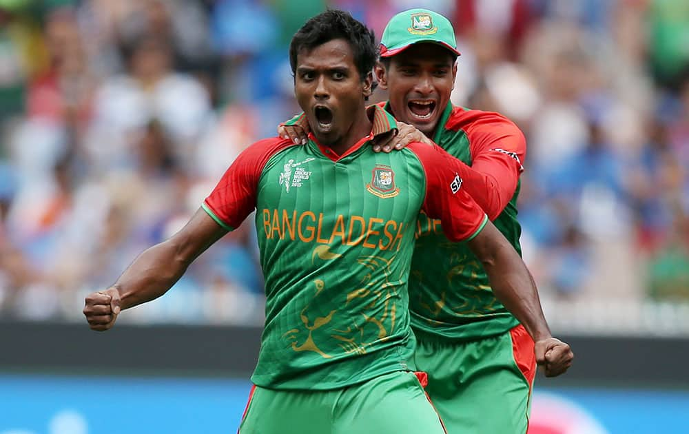 Bangladesh’s Rubel Hossain celebrates with teammate Mahmudullah after taking the wicket of India's Virat Kohli during their Cricket World Cup quarterfinal match in Melbourne, Australia.