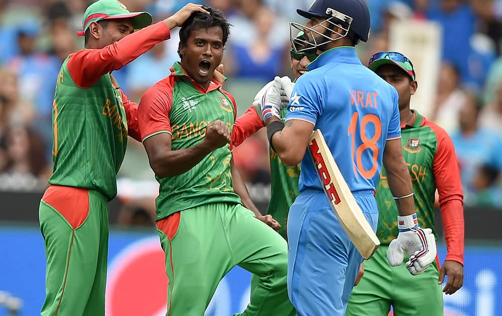 Bangladesh’s Rubel Hossain celebrates with teammate Mahmudullah and Nasir Hossain after taking the wicket of India's Virat Kohli, right, during their Cricket World Cup quarterfinal match in Melbourne, Australia.