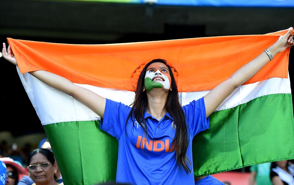 A Indian fan holds up her national flag as she cheers her team during their Cricket World Cup quarterfinal match against Bangladesh in Melbourne, Australia.