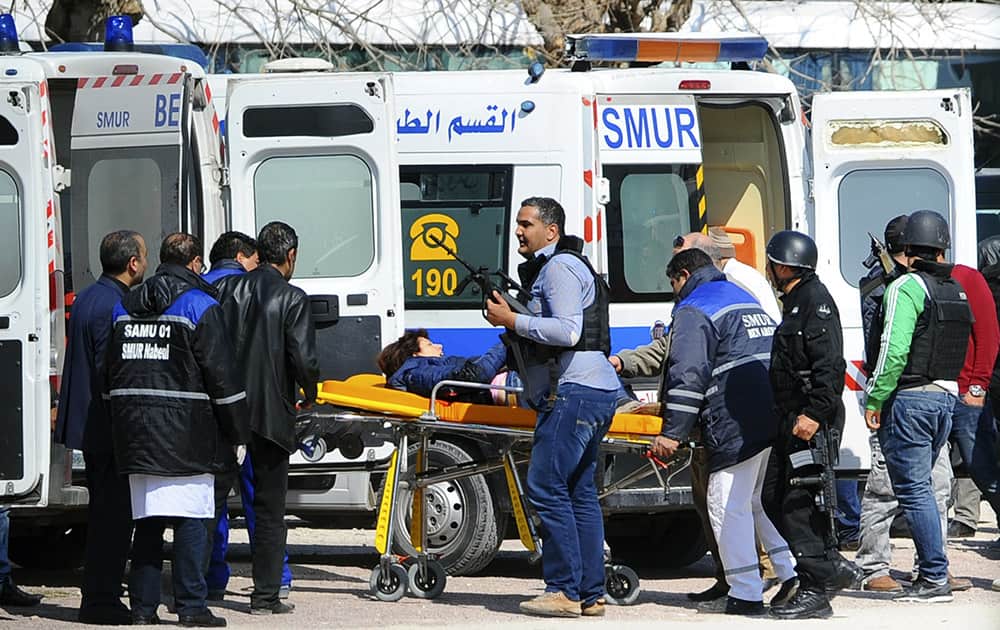 A victim is being evacuated by rescue workers outside the Bardo musum in Tunis, Tunisia.