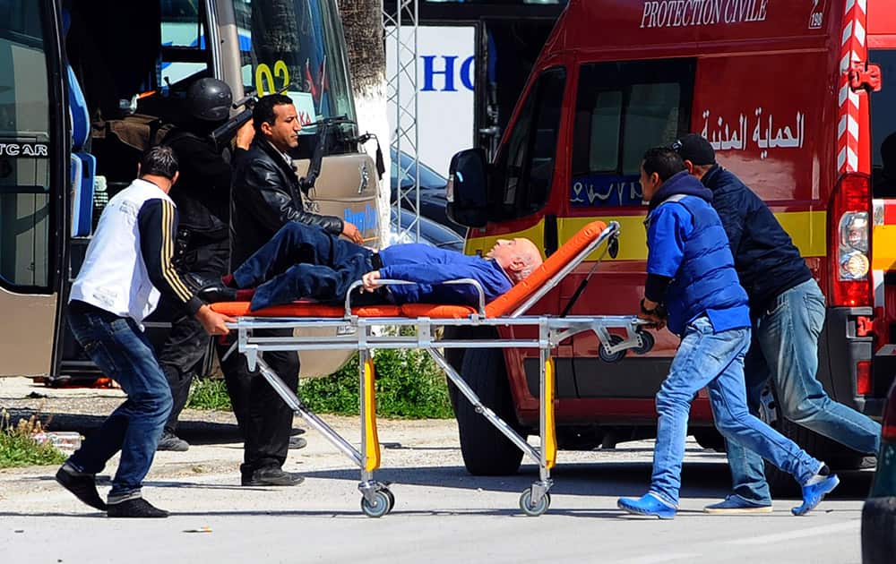 A man is evacuated outside the Bardo Museum after an attack on the museum by gunmen in Tunis, Tunisia.