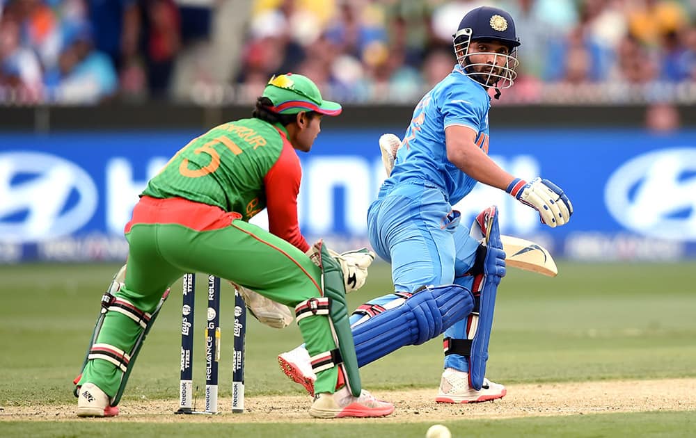 Ajinkya Rahane, watches the ball while batting against Bangladesh during their Cricket World Cup quarterfinal match in Melbourne.