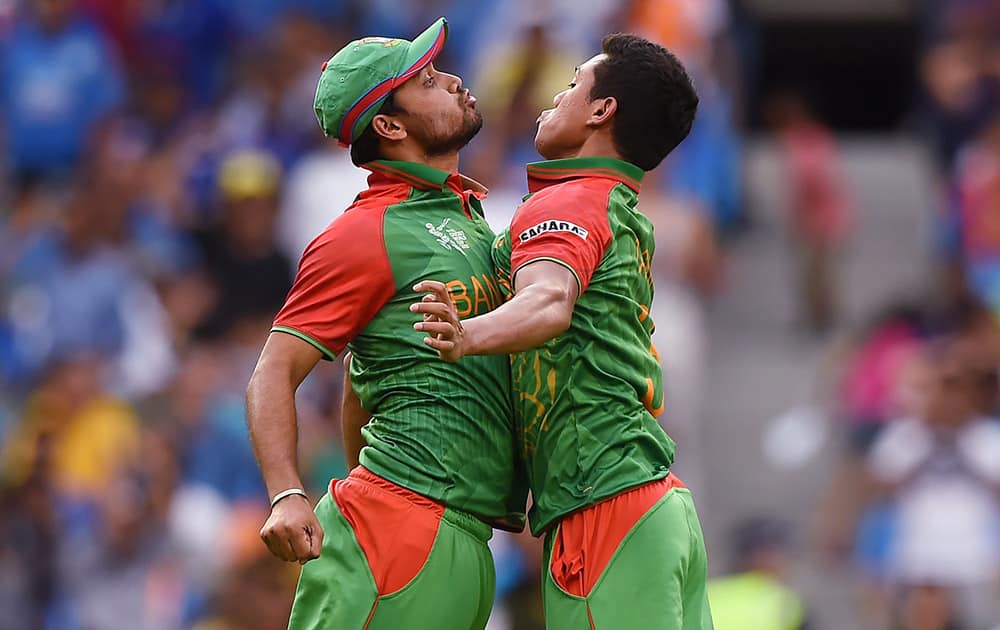 Bangladesh’s Taskin Ahmed, celebrates with his teammate Mashrafe Mortaza after taking the wicket of Ajinkya Rahane during their Cricket World Cup quarterfinal match in Melbourne.