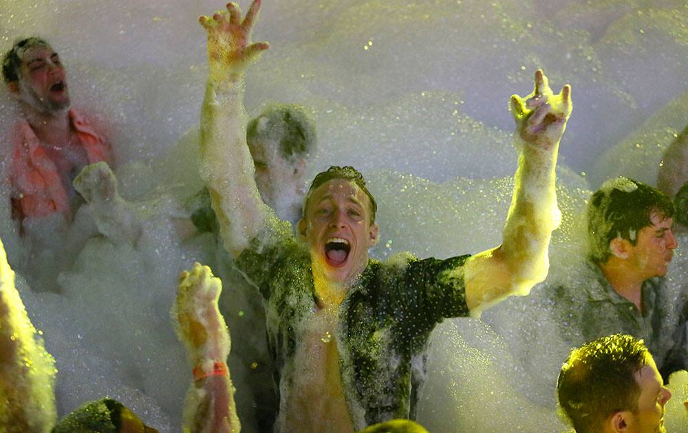 Spring Breakers are covered in foam at The City nightclub in the Caribbean resort city of Cancun, Mexico.