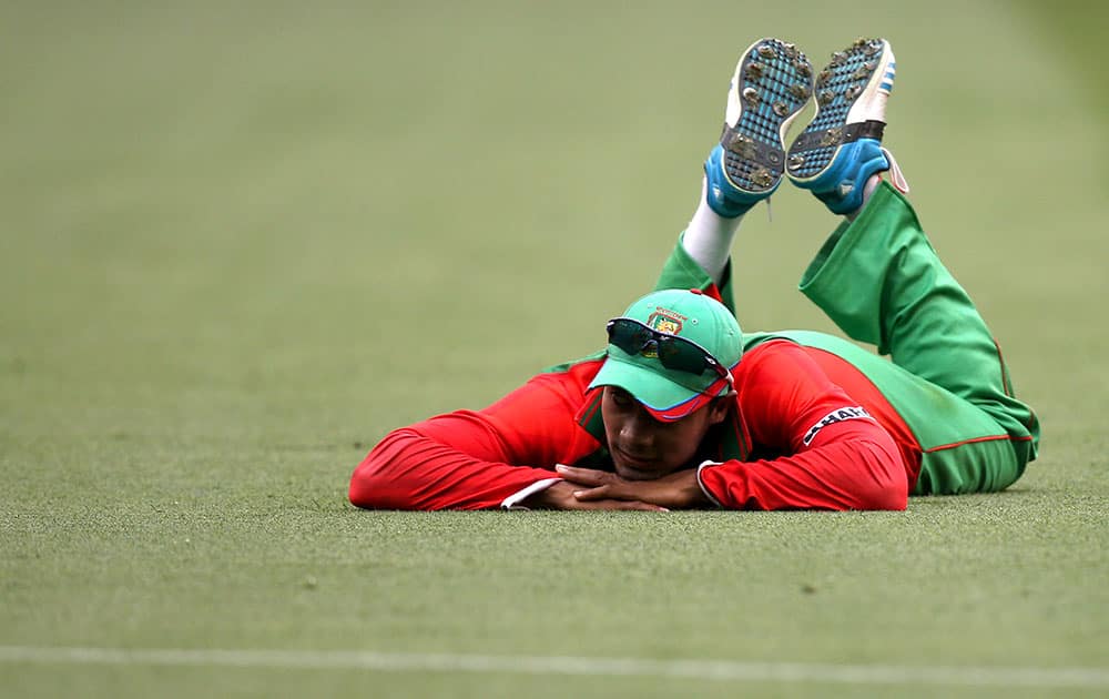 Bangladesh’s Shabbir Rahman Roman rests on the ground during their Cricket World Cup quarterfinal match against India in Melbourne, Australia.