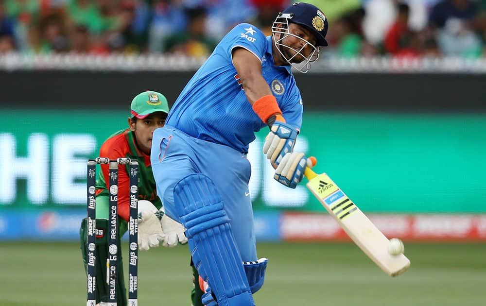 India's Suresh Raina hits the ball for six runs while batting against Bangladesh during their Cricket World Cup quarterfinal match in Melbourne, Australia.