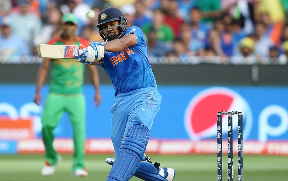 Rohit Sharma hits the ball while batting against Bangladesh during their Cricket World Cup quarterfinal match in Melbourne, Australia.